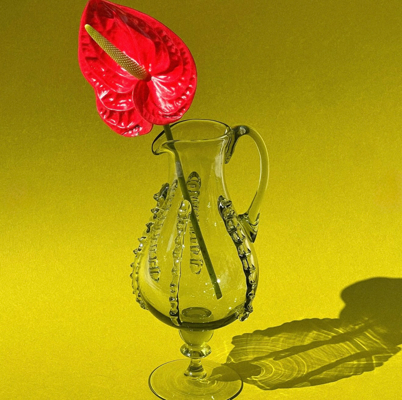 Mouthblown carafe with ornaments on leg