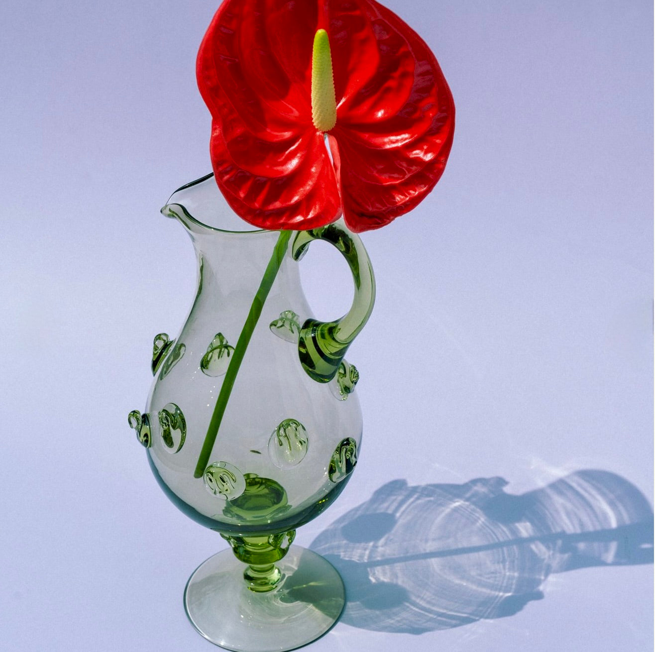 Mouthblown carafe with ornaments on leg